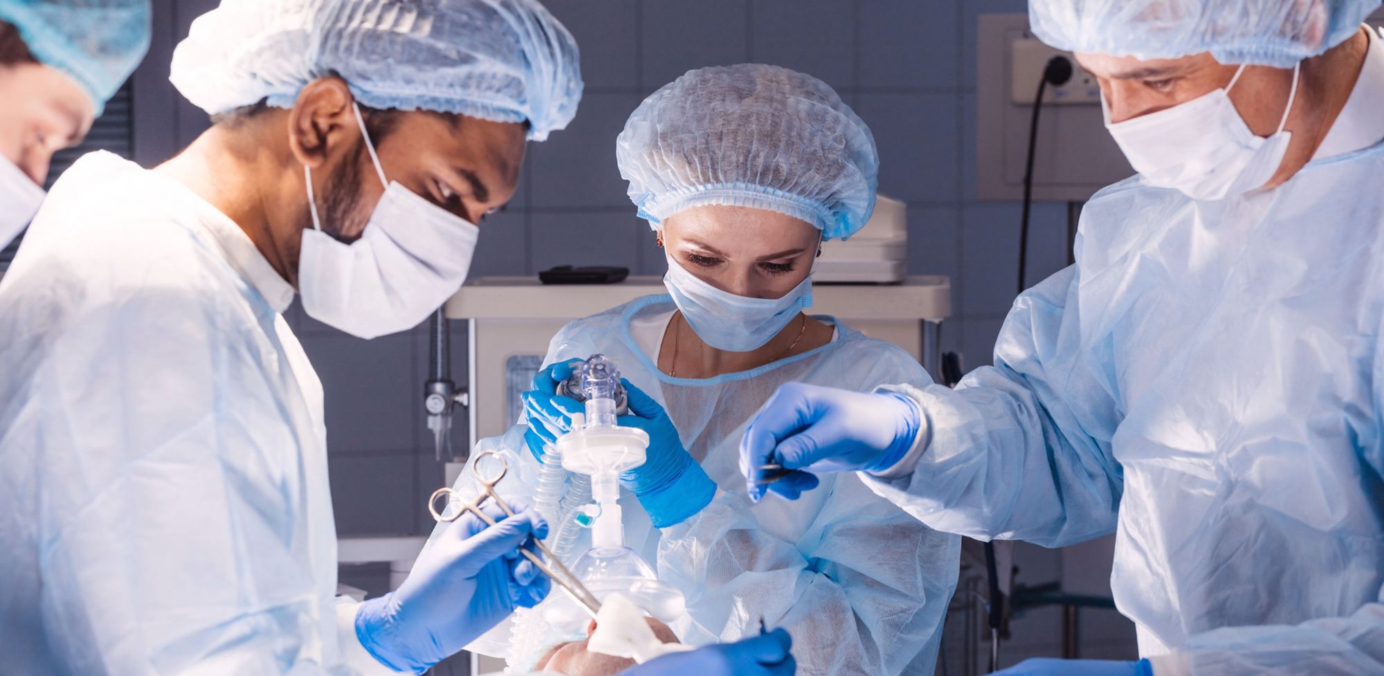Doctors and nurses performing surgery on a patient. 